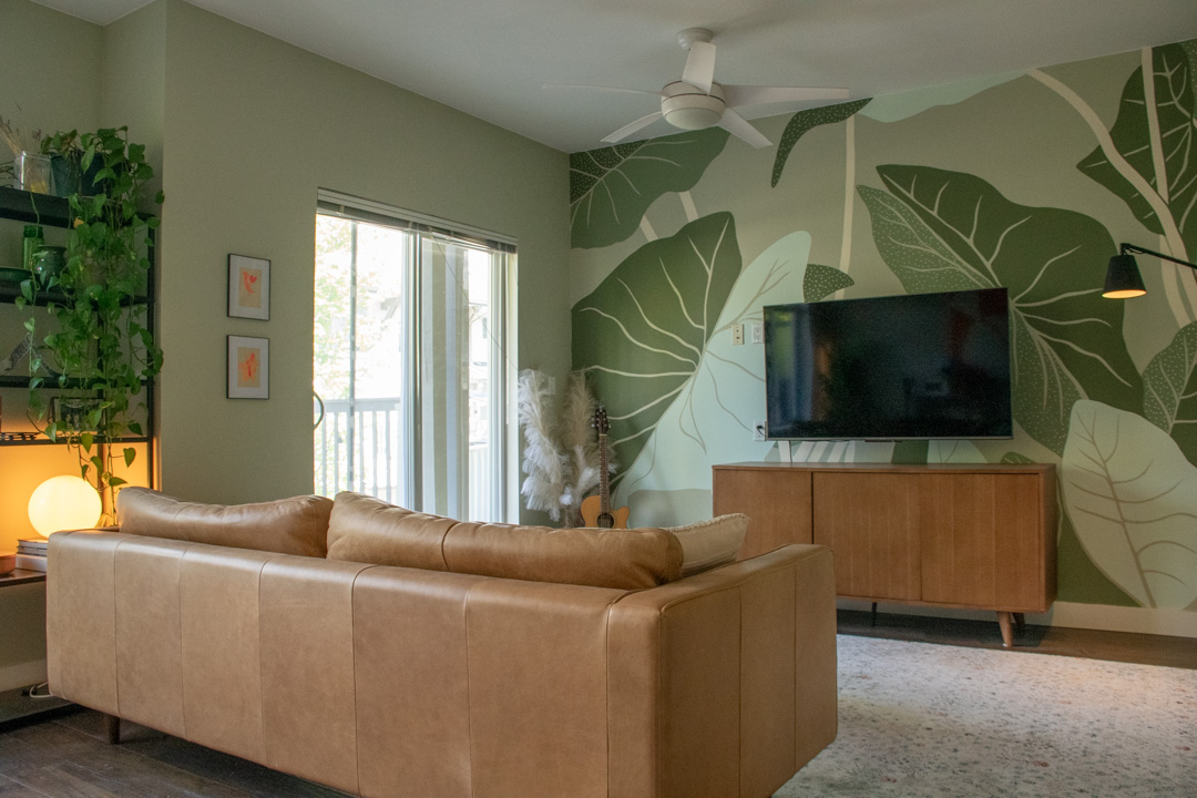 Open-concept living room with engineered hardwood and natural light