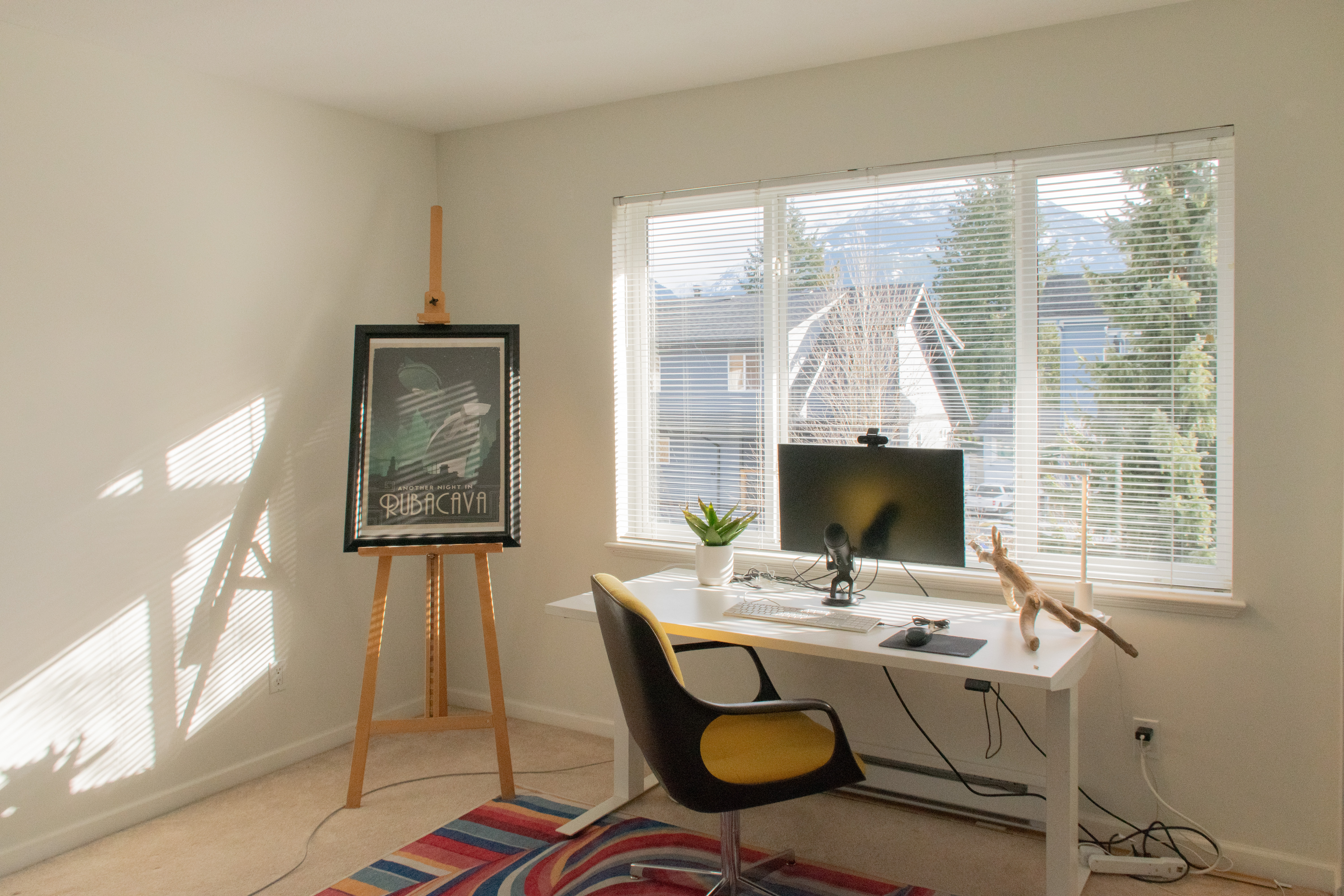 Guest bedroom set up as home office with mountain views
